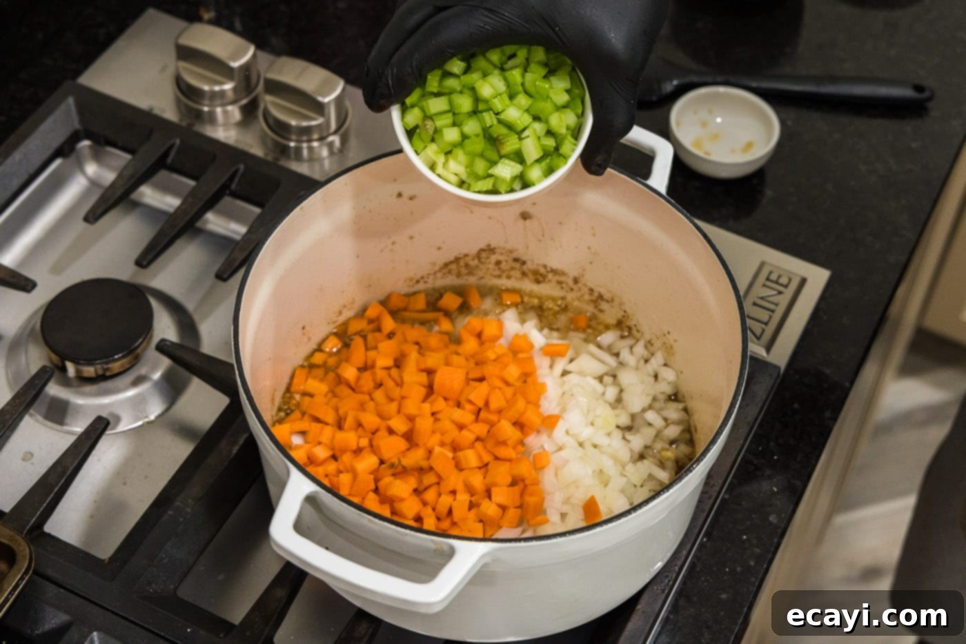 Melt-in-Your-Mouth Braised Beef Shanks 11 Adding chopped celery to a Dutch oven already containing carrots, onion, and garlic simmering in white wine