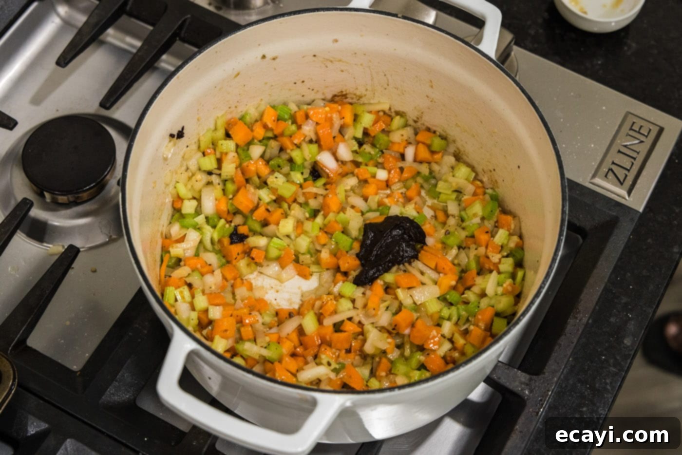 Melt-in-Your-Mouth Braised Beef Shanks 15 Adding beef base to the vegetables in the pot, stirring to dissolve