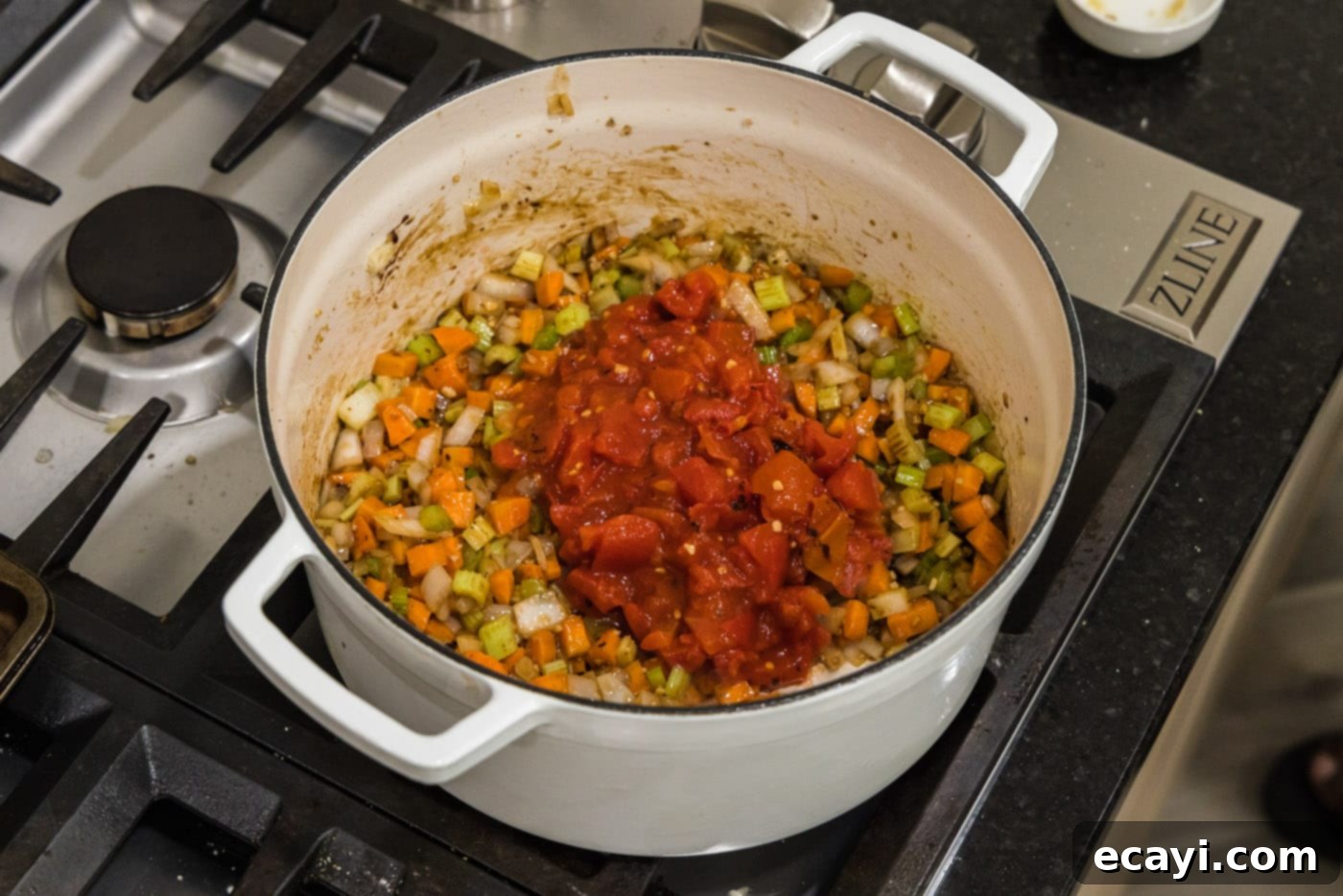 Melt-in-Your-Mouth Braised Beef Shanks 16 Adding canned diced tomatoes to the mixture of celery, onions, and carrots in the Dutch oven
