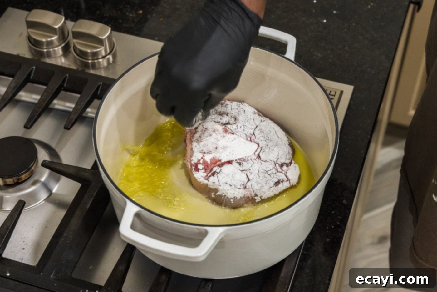 Melt-in-Your-Mouth Braised Beef Shanks 7 Adding cornstarch coated beef shanks to hot olive oil in a Dutch oven