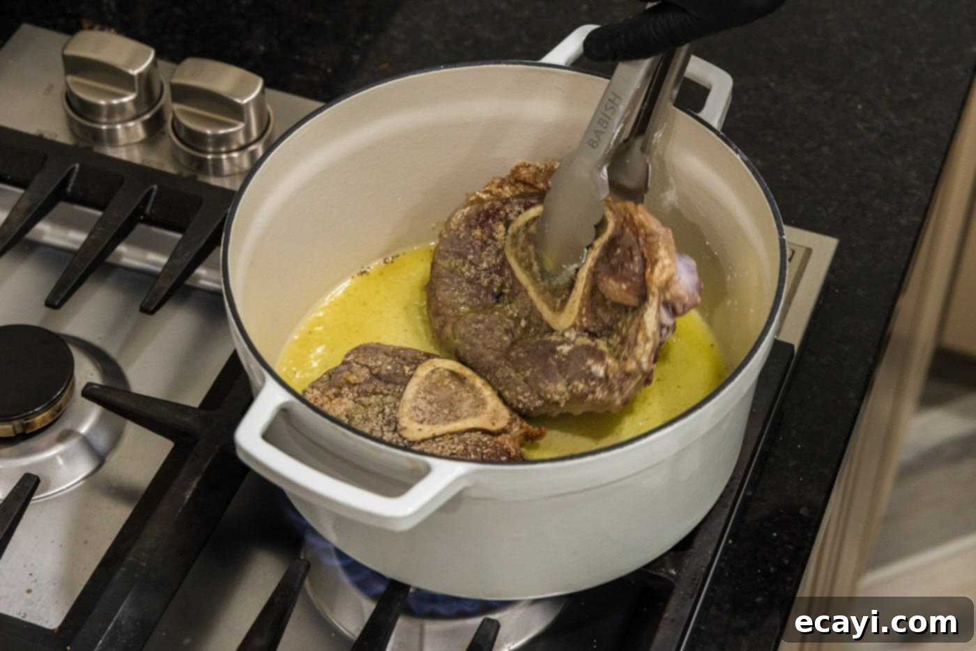 Melt-in-Your-Mouth Braised Beef Shanks 8 Using tongs to flip beef shanks as they sear in a Dutch oven