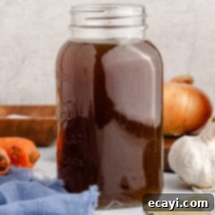 Garden Elixir 12 Close up photo of a jar of clear, golden Vegetable Broth