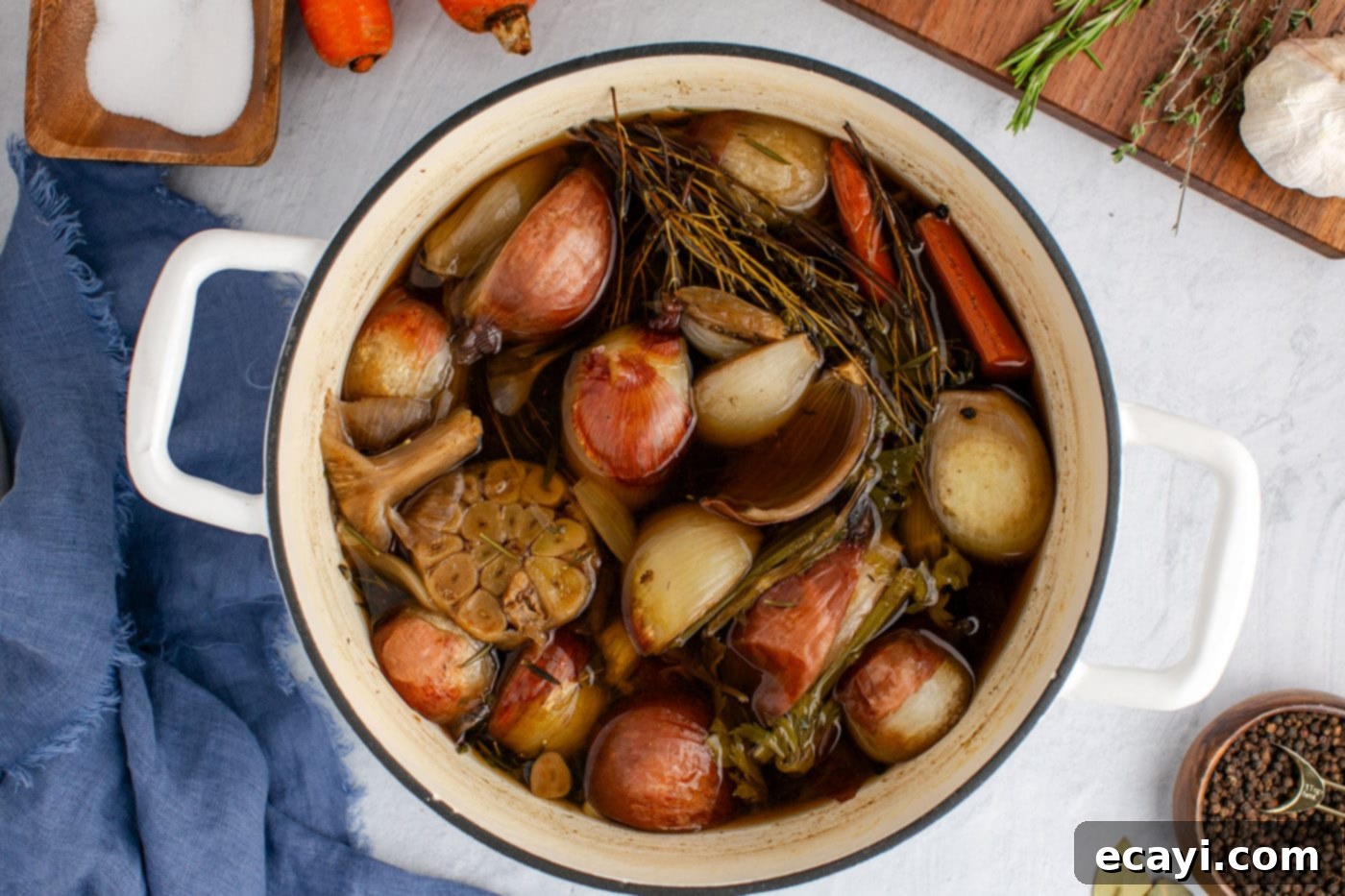 Garden Elixir 8 The vegetable broth gently simmering in a stockpot on the stovetop, with vegetables and herbs visible