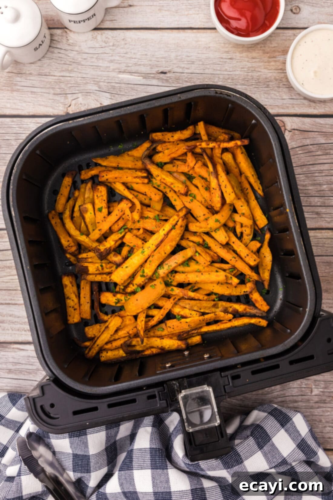 Perfectly Crispy Air Fryer Sweet Potato Fries 2 Air Fryer Sweet Potato Fries in an air fryer basket, perfectly golden and crispy