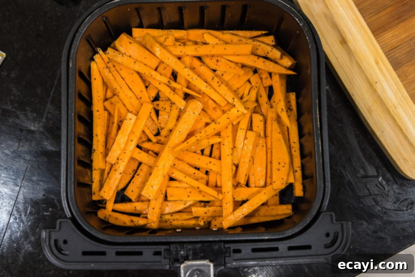 Perfectly Crispy Air Fryer Sweet Potato Fries 11 Sweet potato fries arranged in a single layer in an air fryer basket
