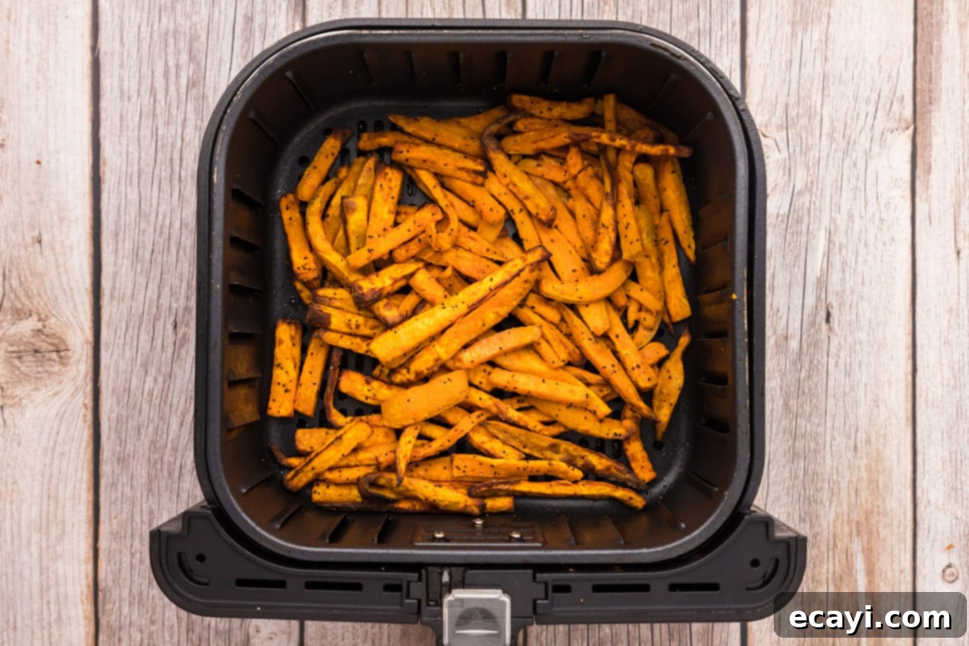 Perfectly Crispy Air Fryer Sweet Potato Fries 12 Finished air fryer sweet potato fries, golden and crispy in the air fryer basket