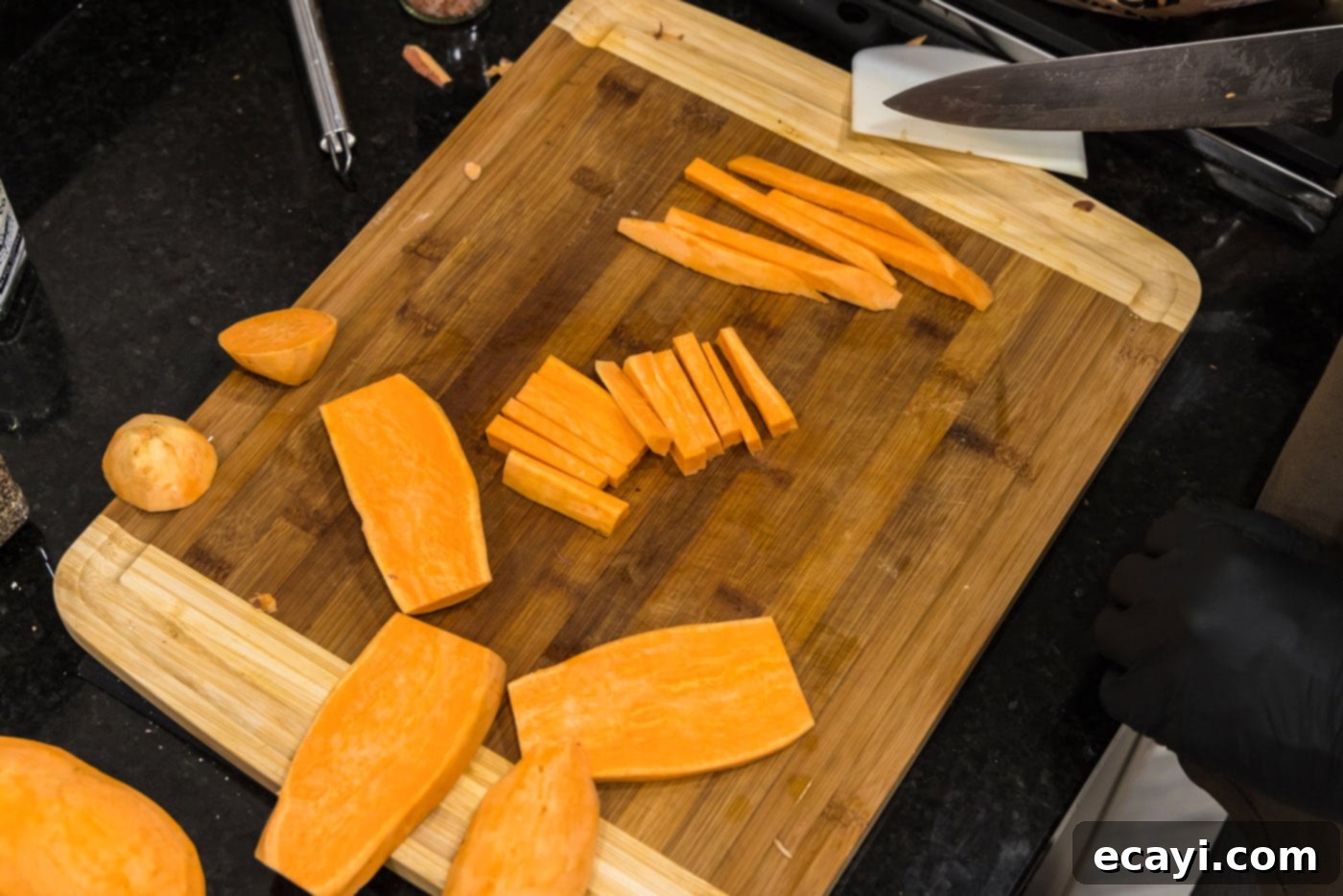 Perfectly Crispy Air Fryer Sweet Potato Fries 6 Slicing peeled sweet potatoes into thin, even sticks for fries