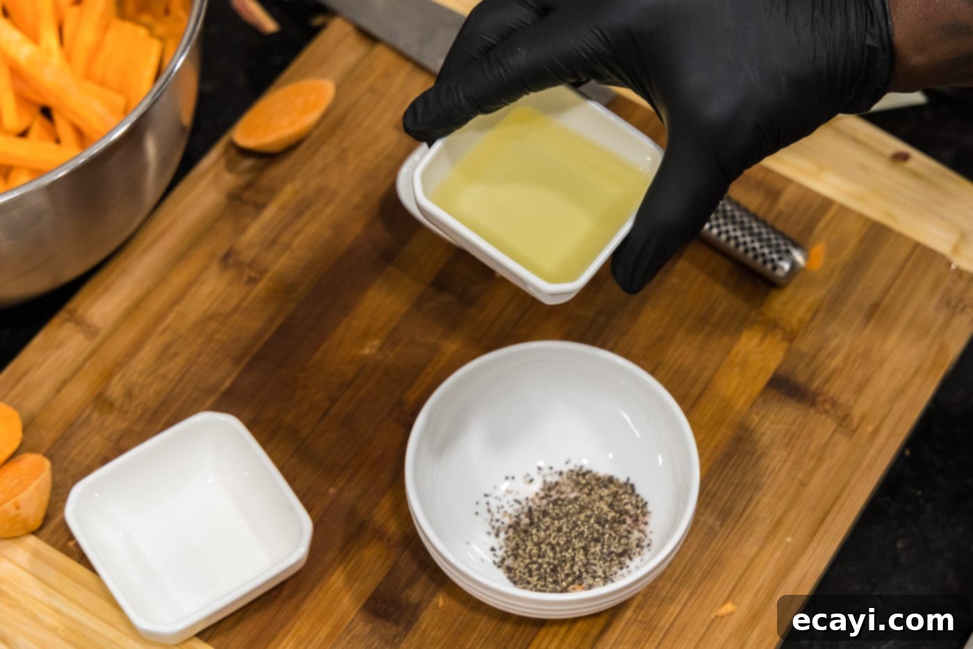 Perfectly Crispy Air Fryer Sweet Potato Fries 7 Adding olive oil to salt and pepper in a small mixing bowl