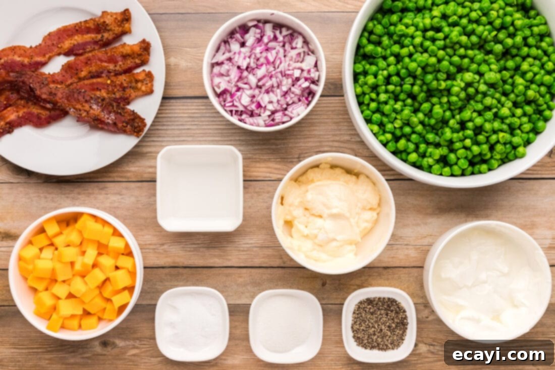 Refreshing Creamy Pea Salad 4 A collection of fresh ingredients laid out for making Pea Salad, including peas, bacon, onion, and cheese.