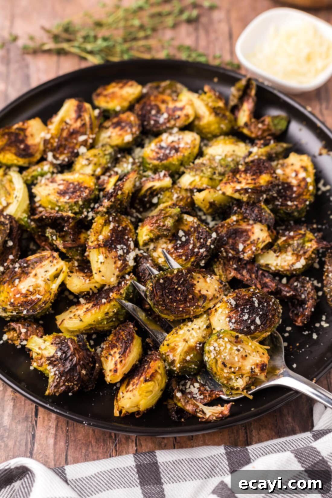 Crispy Roasted Brussels Sprouts 3 Plate of Roasted Brussel Sprouts with a fork, ready to eat