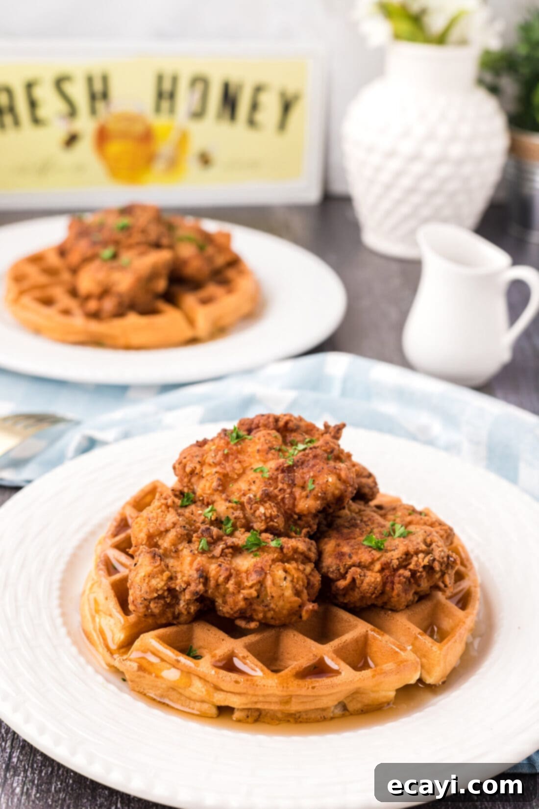 Southern Comfort Bliss 2 Two plates of Chicken and Waffles, showcasing crispy chicken and golden waffles