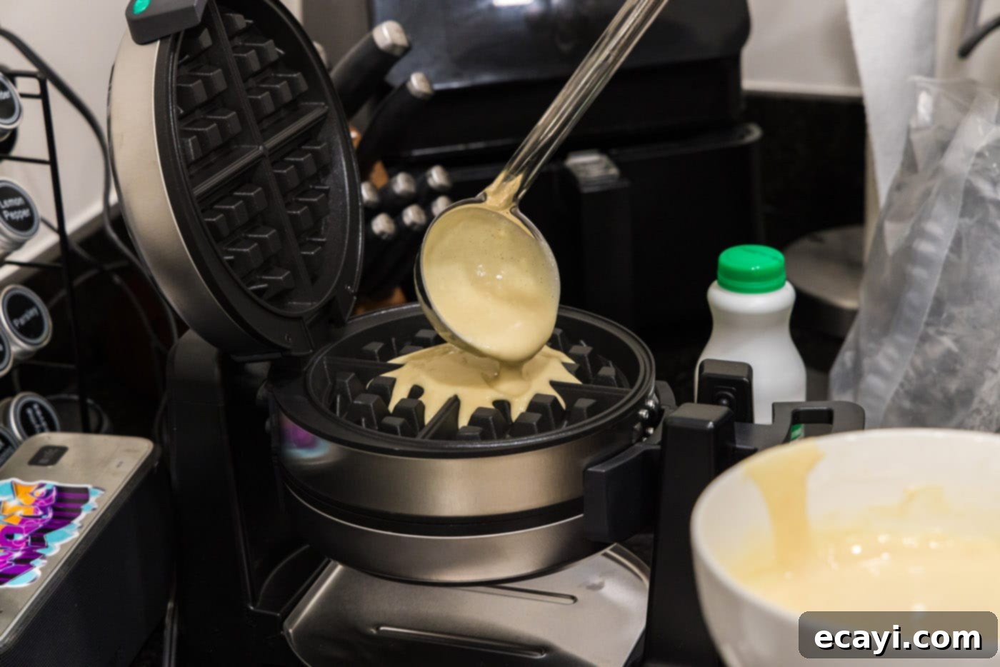 Southern Comfort Bliss 11 Ladle pouring waffle batter into a hot waffle iron