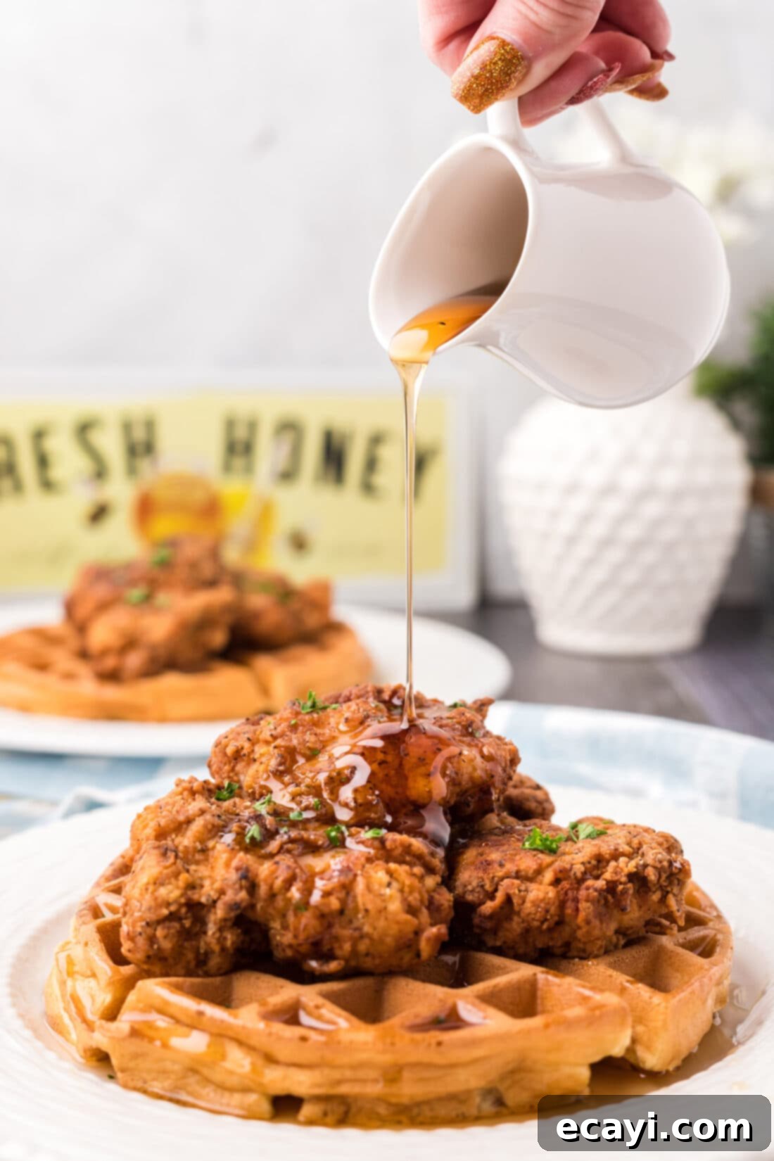 Southern Comfort Bliss 3 Syrup being generously drizzled over a plate of Chicken and Waffles, ready to be enjoyed