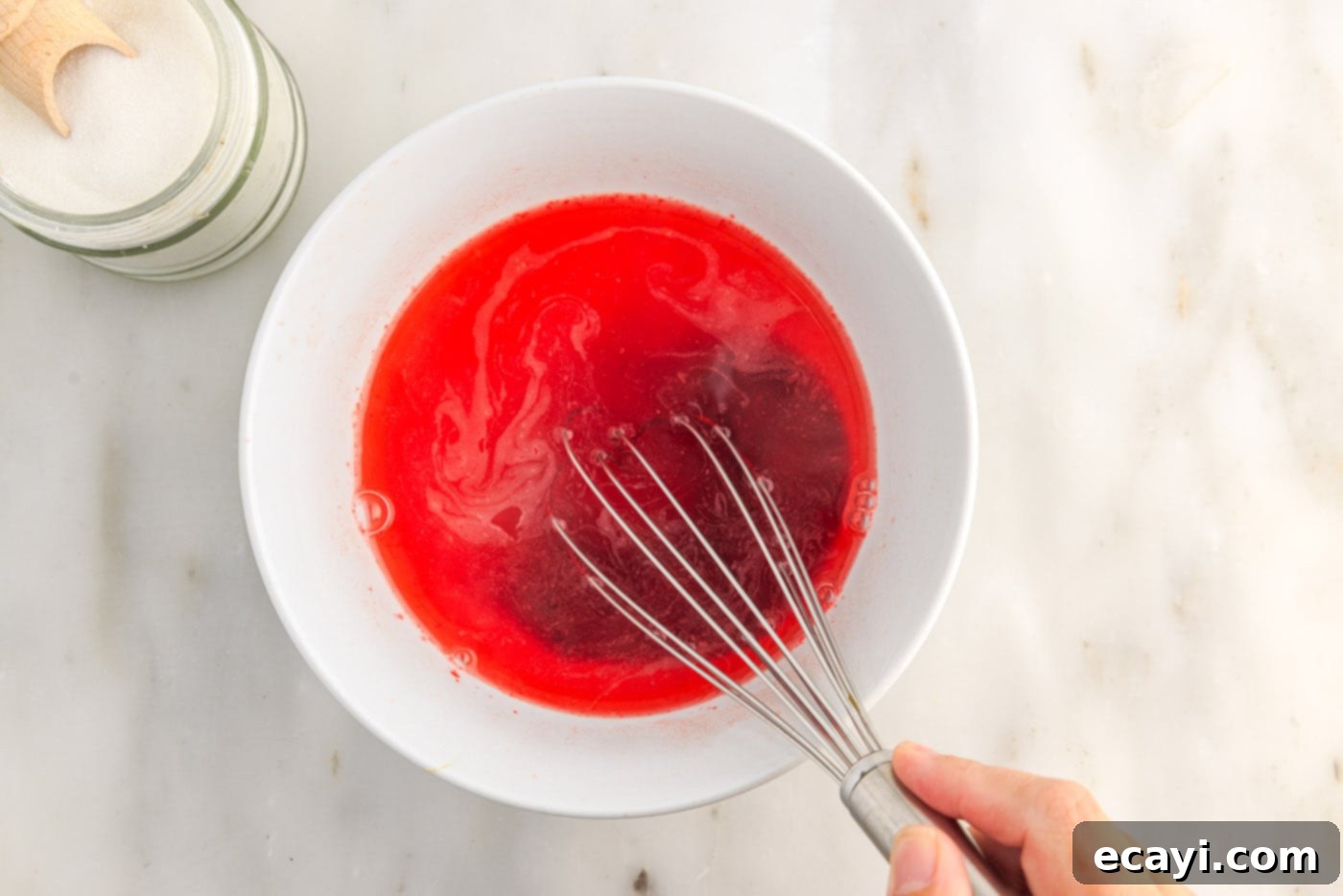 Colorful Gelatin Ice Pops 6 whisking jello powder and sugar with boiling water in a bowl
