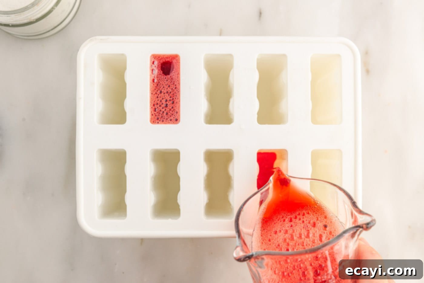 Colorful Gelatin Ice Pops 8 pouring jello mixture into popsicle molds