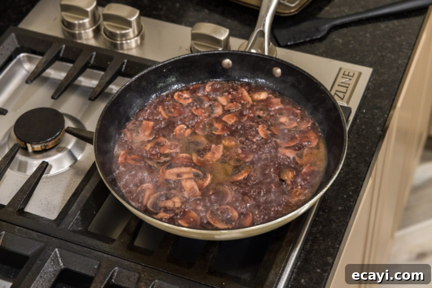 Classic Veal Marsala 12 Rich mushroom Marsala sauce simmering in a skillet, almost ready.