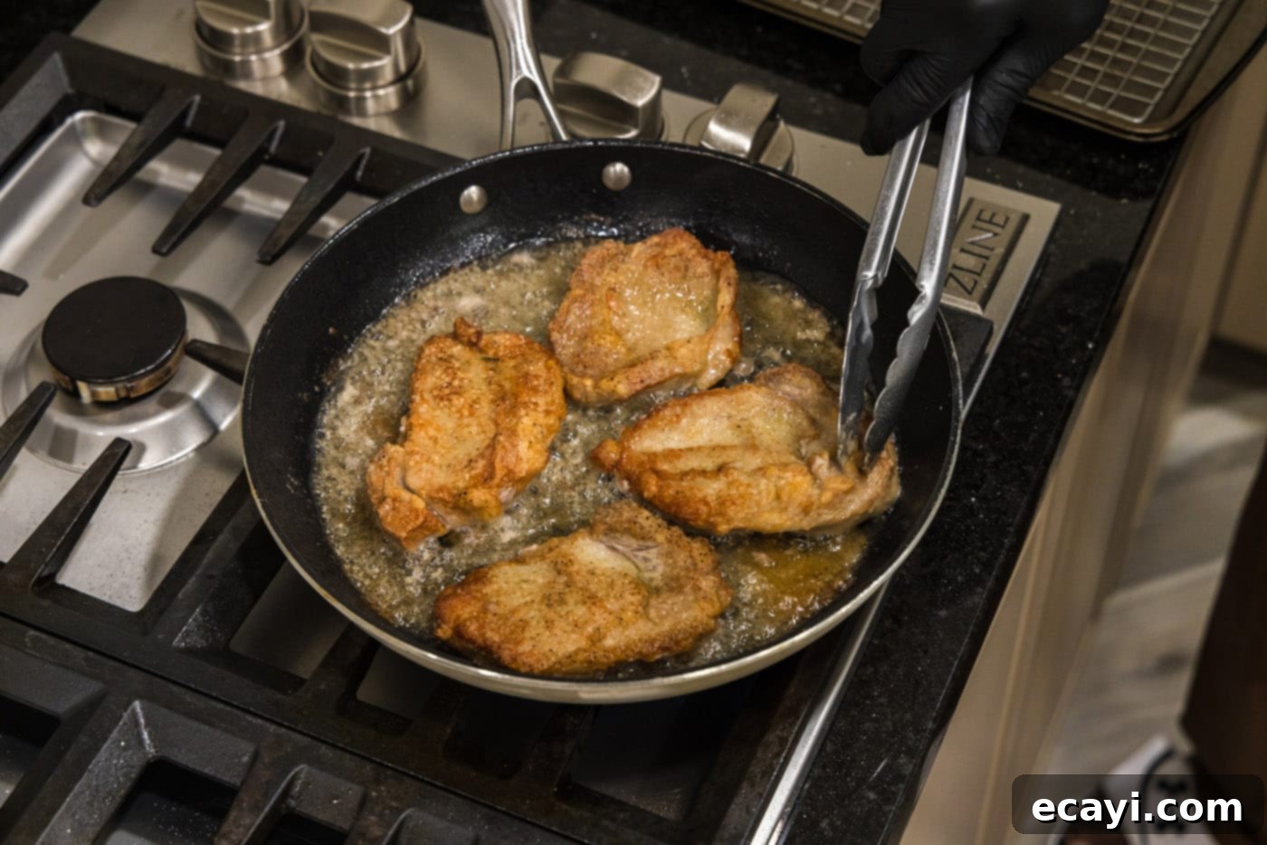 Classic Veal Marsala 8 Tongs gently flipping golden-brown veal chops in a hot skillet.