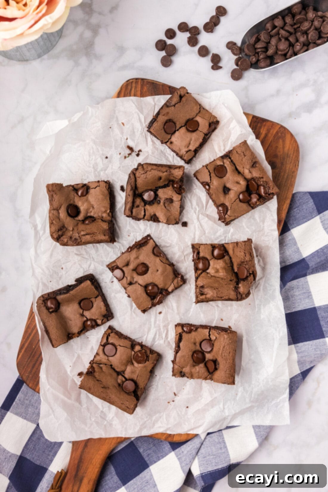 Foolproof Cake Mix Brownies 2 Cake Mix Brownies cut into squares on parchment paper, showcasing their fudgy texture