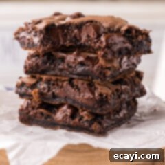 Foolproof Cake Mix Brownies 16 Stack of Cake Mix Brownies with a bite taken out of the top one