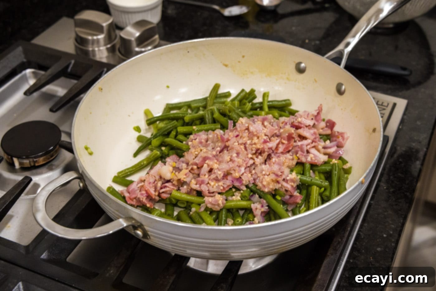 Homestyle Southern Green Beans 11 Adding the cooked shallots, bacon, and garlic back into the tender southern green beans