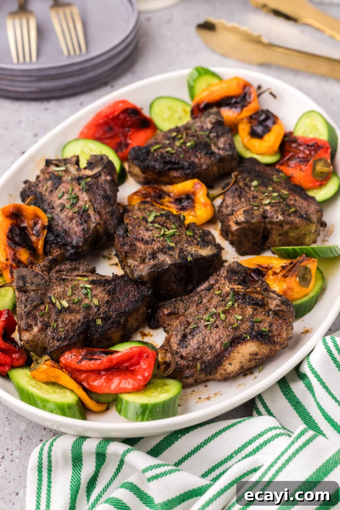 Succulent Grilled Lamb Loin 2 Grilled Lamb Loin Chops on a platter with vegetables, showcasing a perfect sear and inviting presentation