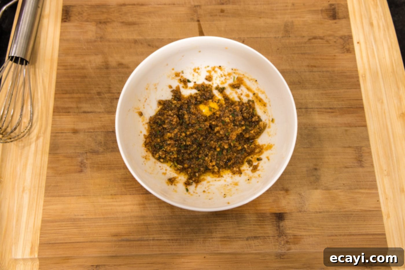 Succulent Grilled Lamb Loin 6 Seasonings mixed with olive oil forming a wet rub in a bowl