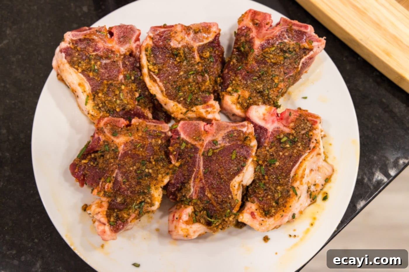 Succulent Grilled Lamb Loin 8 Seasoned lamb loin chops neatly arranged on a plate, ready for grilling