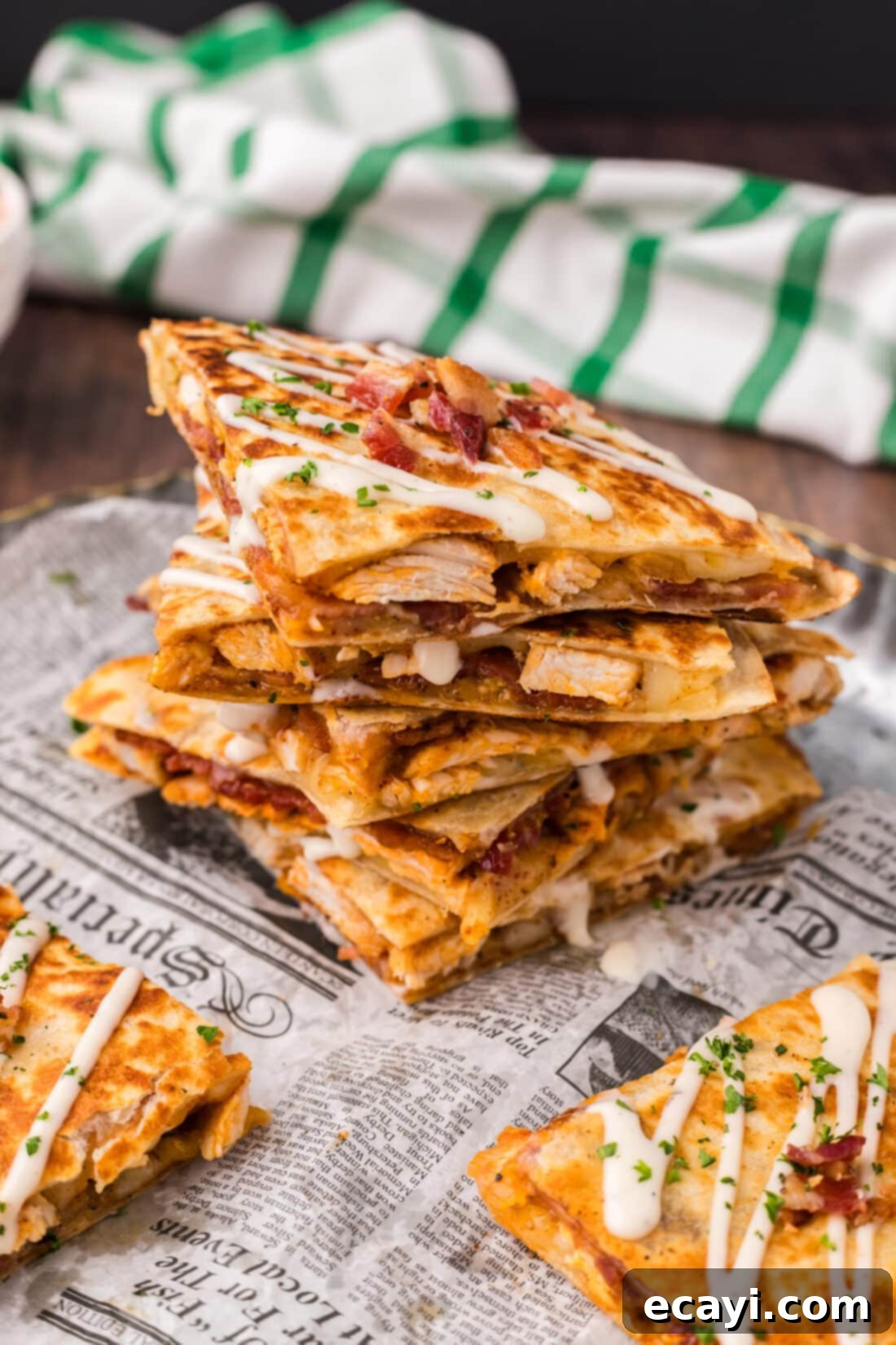 Ultimate Chicken Bacon Ranch Quesadillas 2 Stack of Golden Chicken Bacon Ranch Quesadillas topped with a drizzle of creamy ranch dressing, ready to be served.