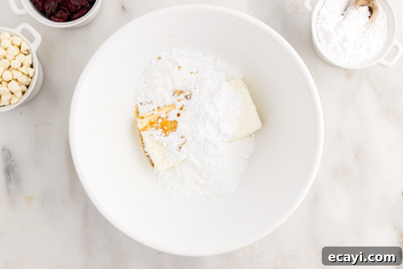 Dreamy Cranberry Squares 11 Powdered sugar, cream cheese, vanilla, and orange oil in a mixing bowl for frosting
