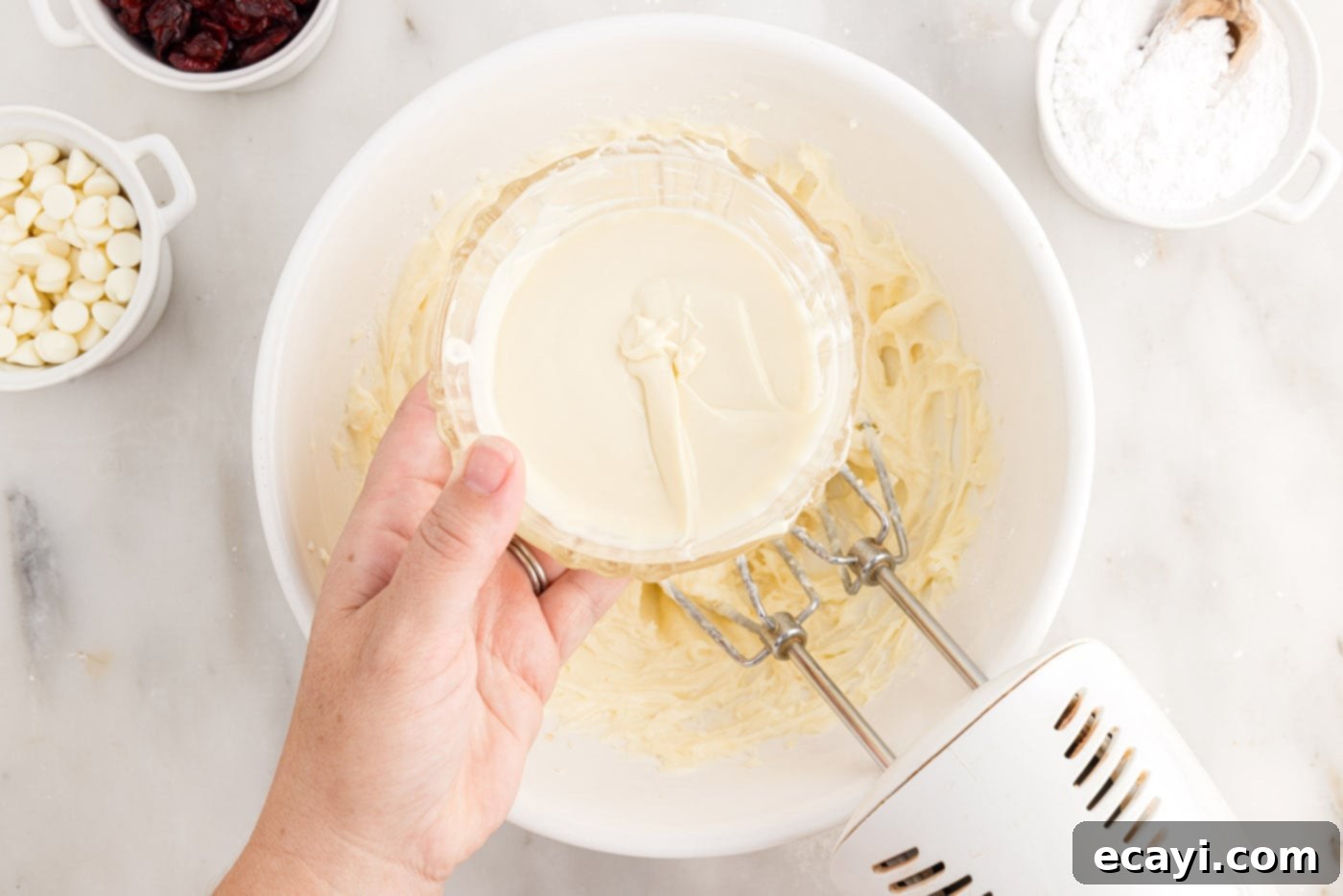 Dreamy Cranberry Squares 12 Adding melted white chocolate to the cream cheese frosting mixture