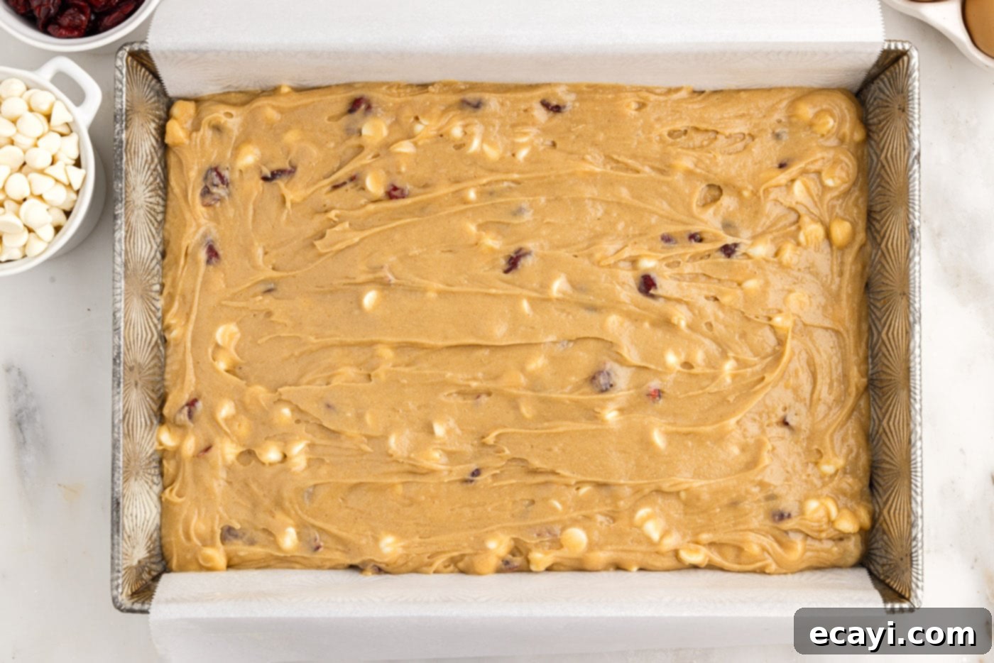 Dreamy Cranberry Squares 10 White chocolate cranberry blondies baking in a 9x13 inch pan