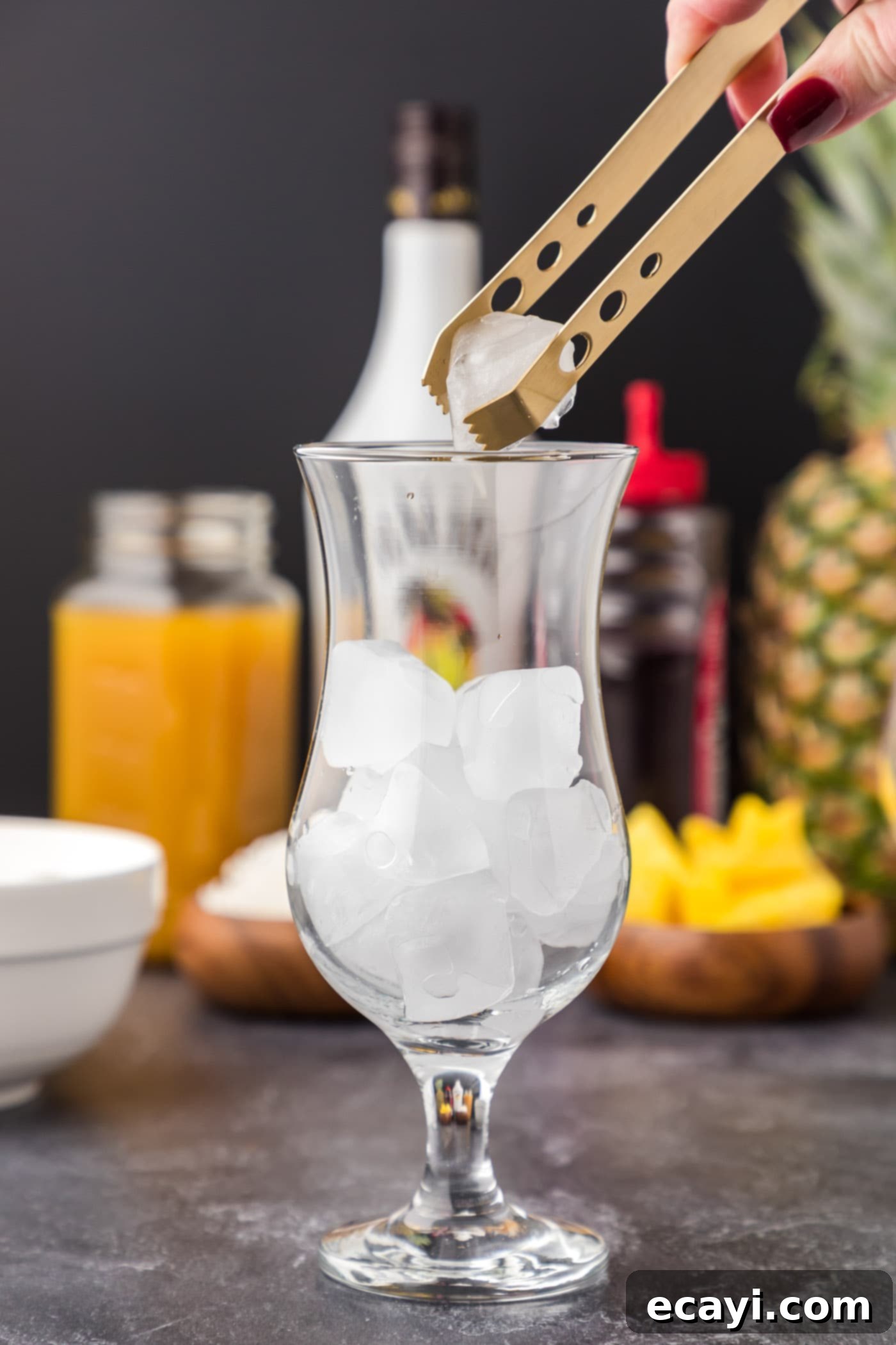 Malibu's Golden Hour 5 adding ice cubes to hurricane glass
