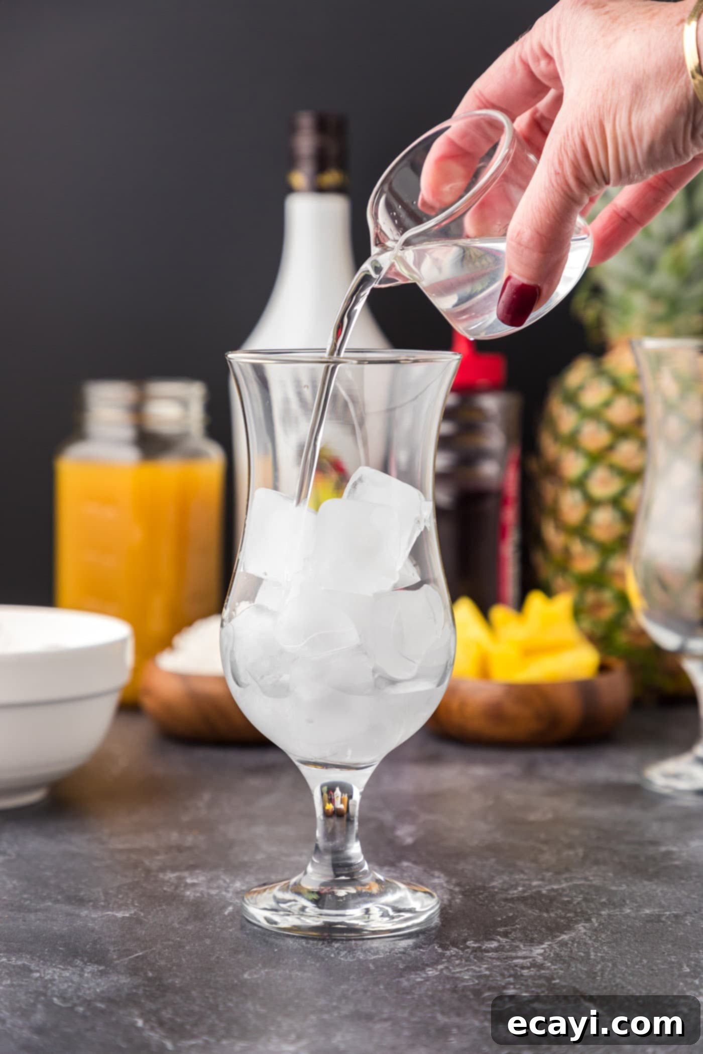 Malibu's Golden Hour 6 pouring coconut rum into glass of ice