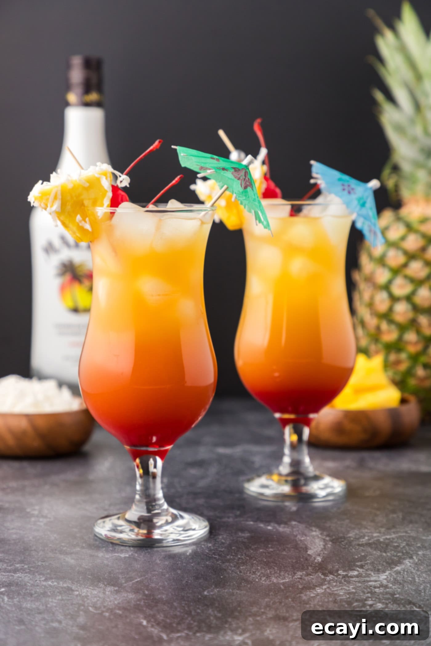Malibu's Golden Hour 9 Malibu sunset cocktails with pineapple wedge and shredded coconut garnish
