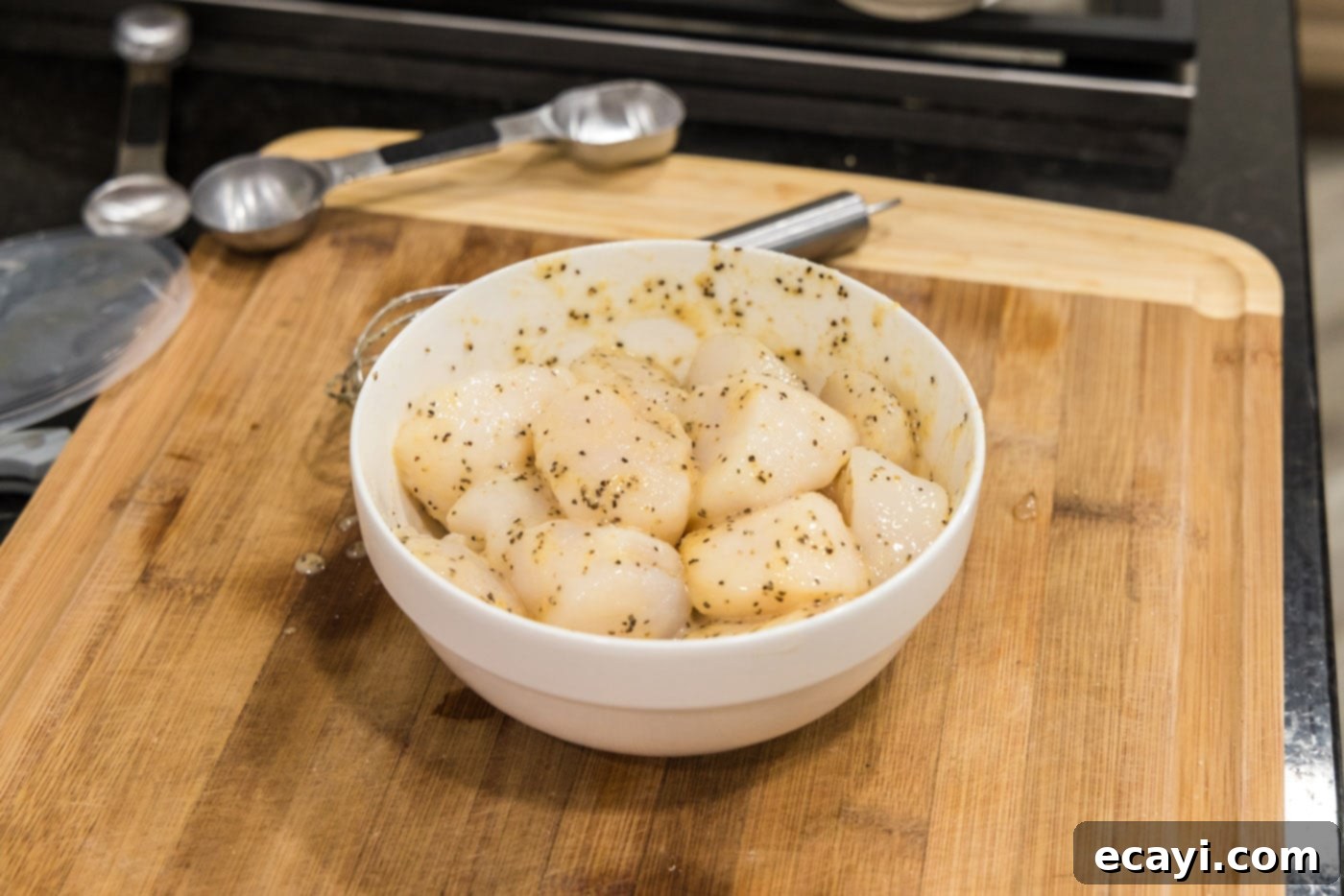 Succulent Grilled Scallops 8 scallops in a bowl with butter mixture