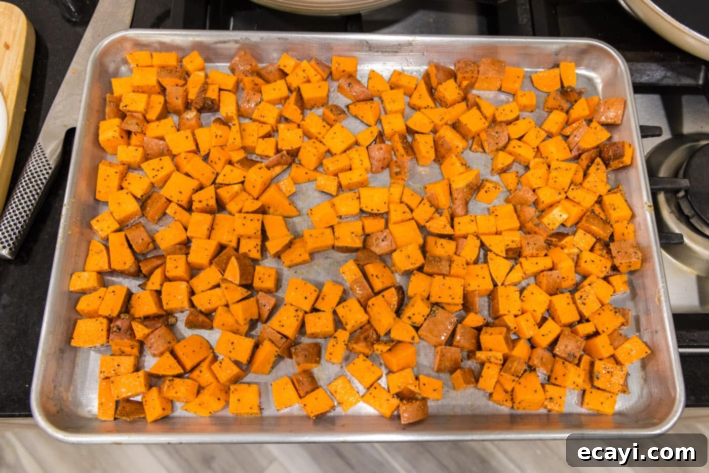 The Ultimate Roasted Sweet Potatoes 8 cubed sweet potatoes on a baking sheet
