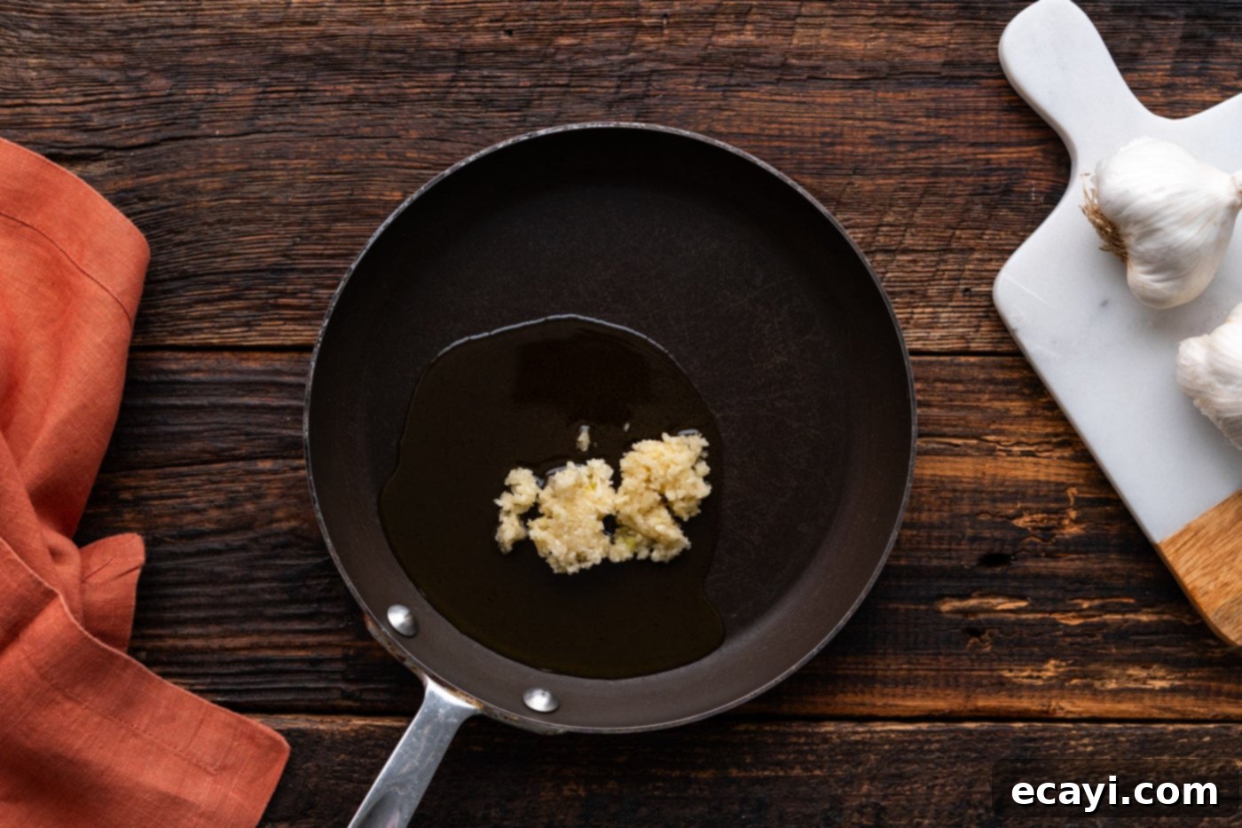 Ultimate Garlic Parmesan Wing Sauce 5 minced garlic in a skillet with oil