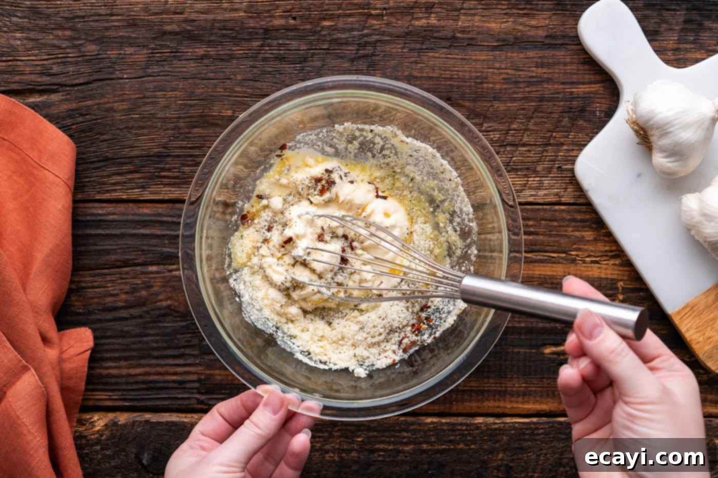 Ultimate Garlic Parmesan Wing Sauce 8 mixing parmesan garlic wing sauce ingredients in a bowl