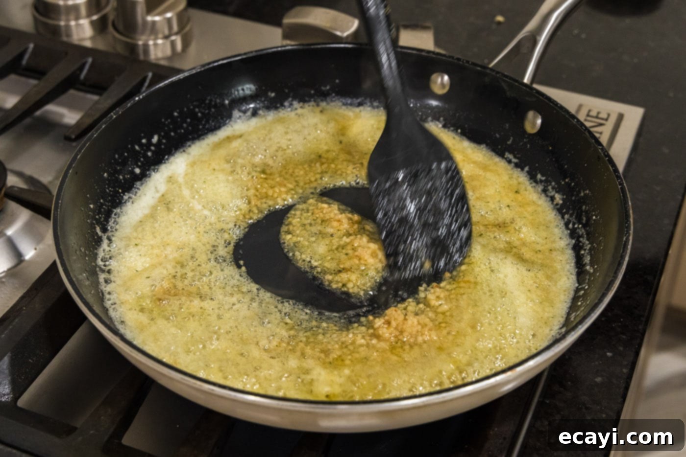 Crispy Garlic Parmesan Wings 11 Adding minced garlic to the seasoned butter in a skillet