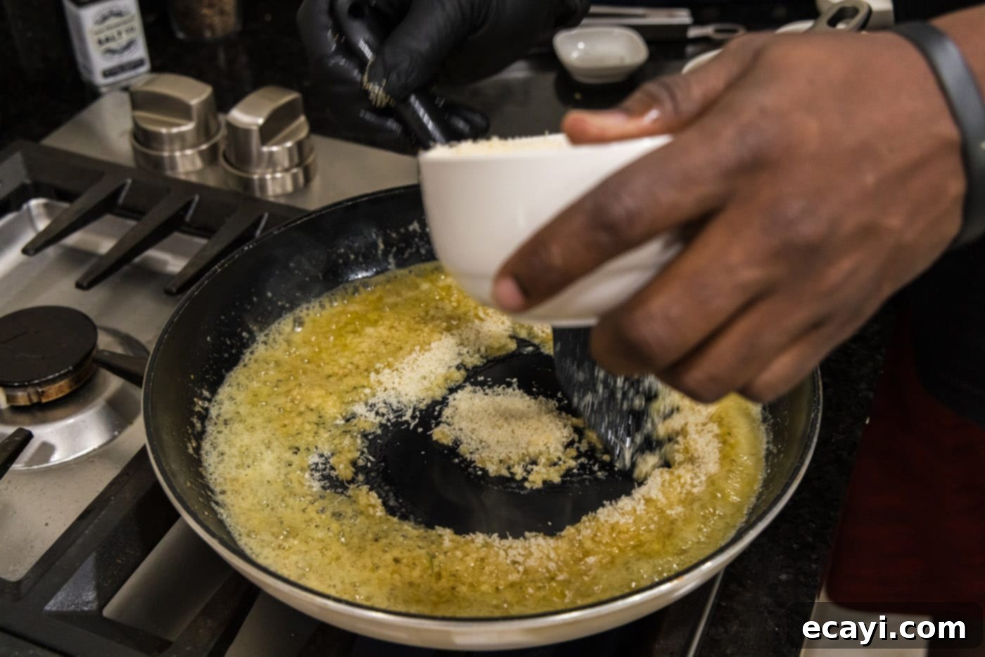 Crispy Garlic Parmesan Wings 12 Gradually adding grated Parmesan cheese to the garlic butter mixture
