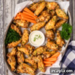 Crispy Garlic Parmesan Wings 18 Serving tray of Crispy Garlic Parmesan Wings with a bowl of dipping sauce
