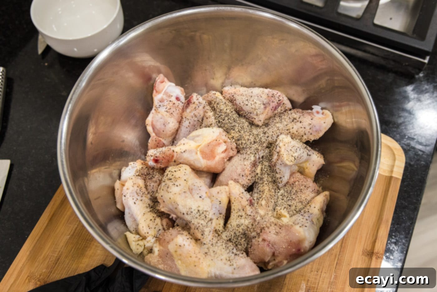 Crispy Garlic Parmesan Wings 5 Chicken wings in a bowl seasoned with garlic salt, onion powder, and pepper