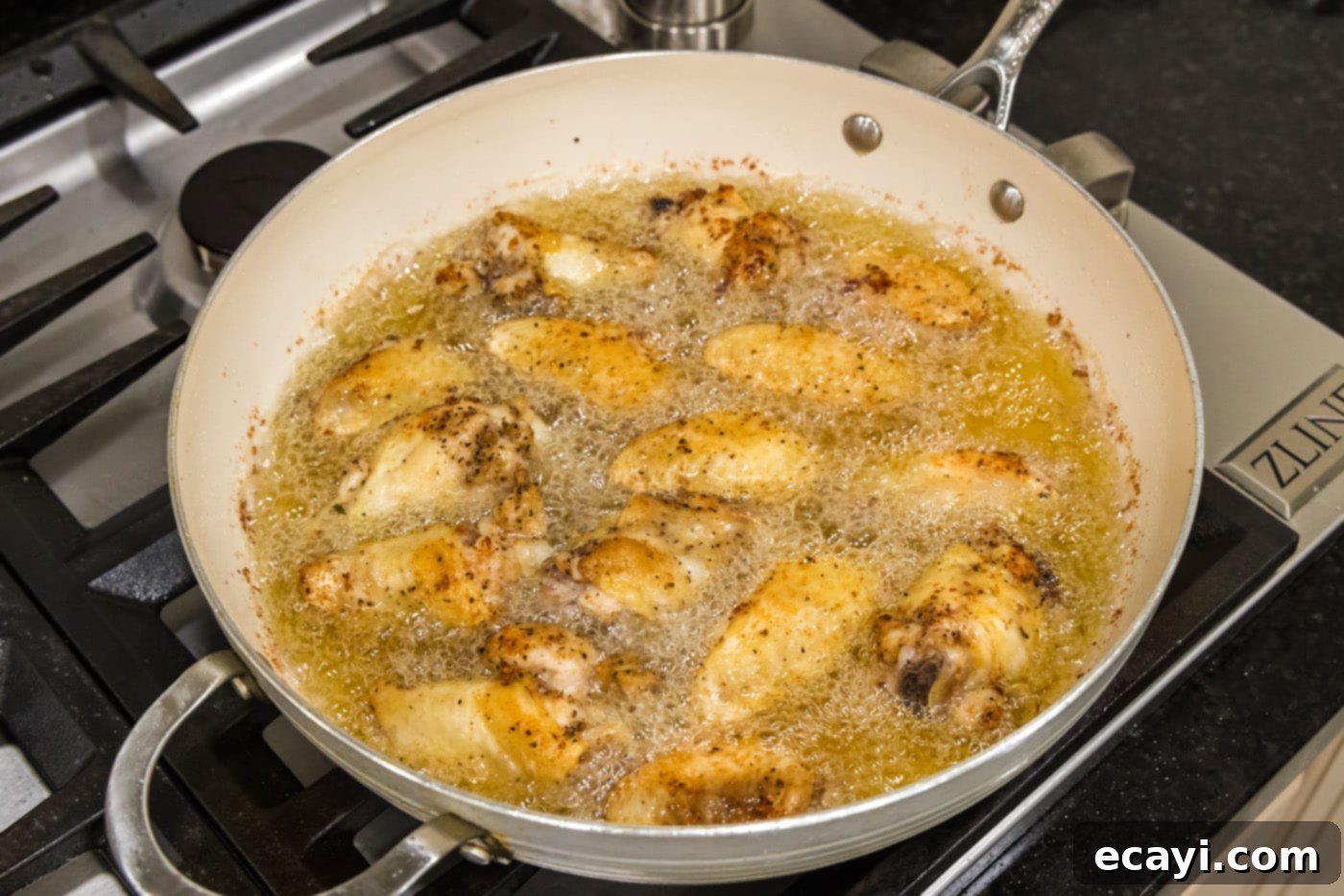 Crispy Garlic Parmesan Wings 8 Close-up of chicken wings frying to golden perfection