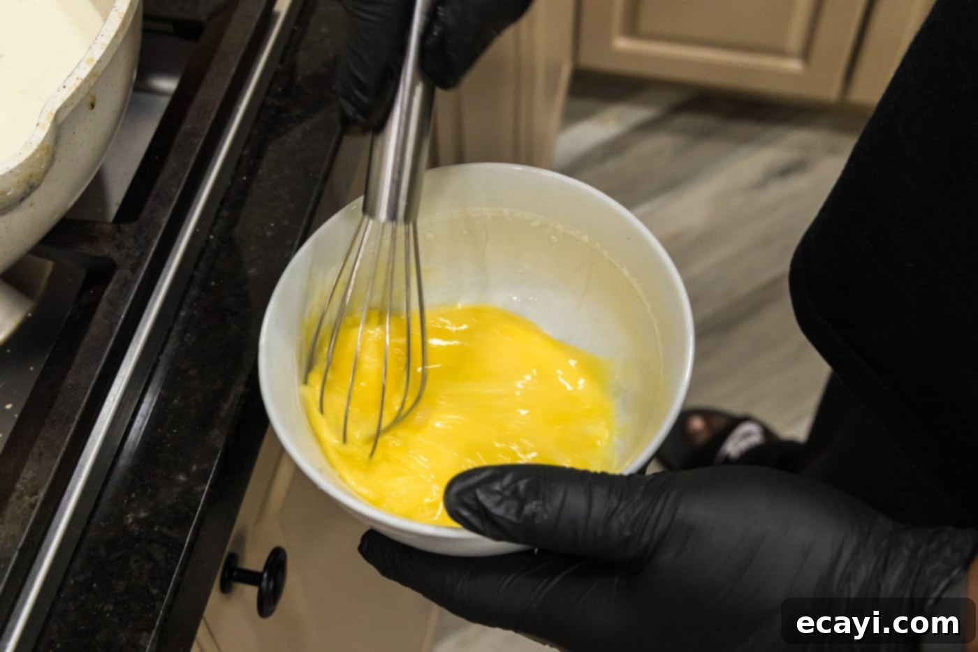 Surf and Turf Carbonara 11 whisking eggs in a bowl