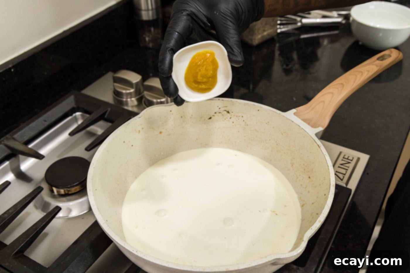 Surf and Turf Carbonara 10 adding chicken base to skillet of heavy cream