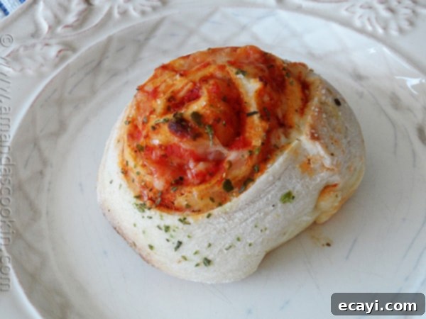 Pizza Pinwheels 3 A plate of warm, cheesy pizza roll ups, ready to be served as a snack.
