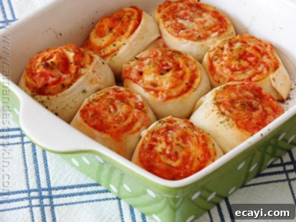 Pizza Pinwheels 4 Pizza dough rolled out and covered with pizza sauce, mozzarella, and parmesan cheese.