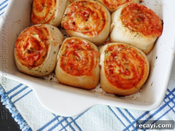 Pizza Pinwheels 5 A close-up photo of baked pizza roll ups, golden brown and cheesy.