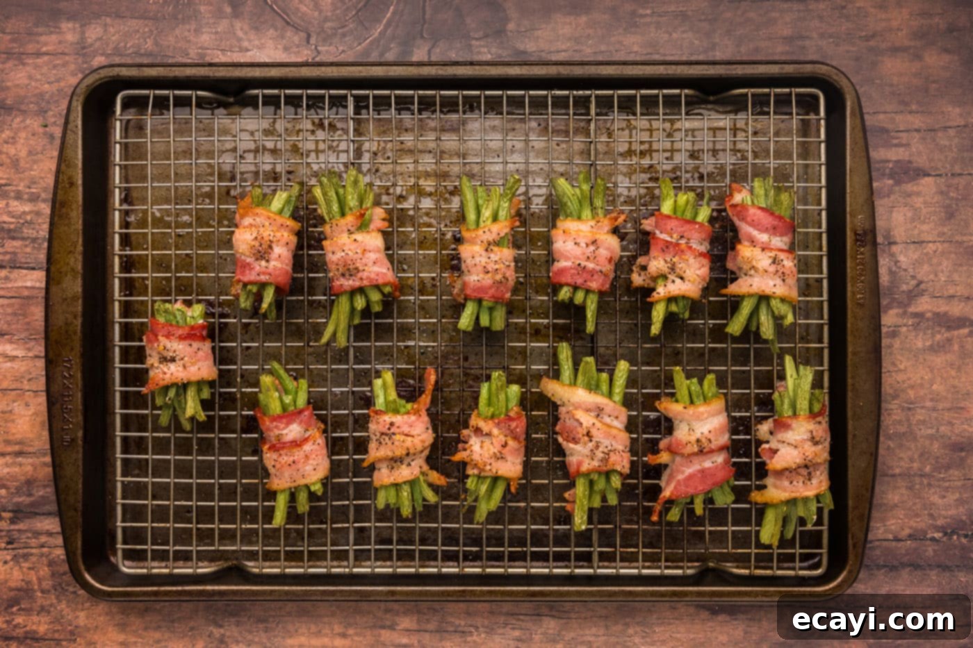 Bacon Green Bean Bundles 10 Overhead shot of freshly baked bacon wrapped green beans, golden and crispy, on a wire rack