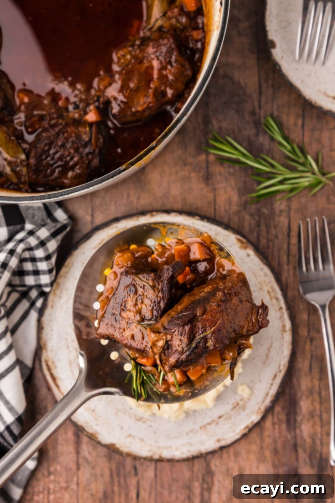 Fork-Tender Beef Short Ribs 3 Spoonful of Braised Beef Short Ribs held over a plate